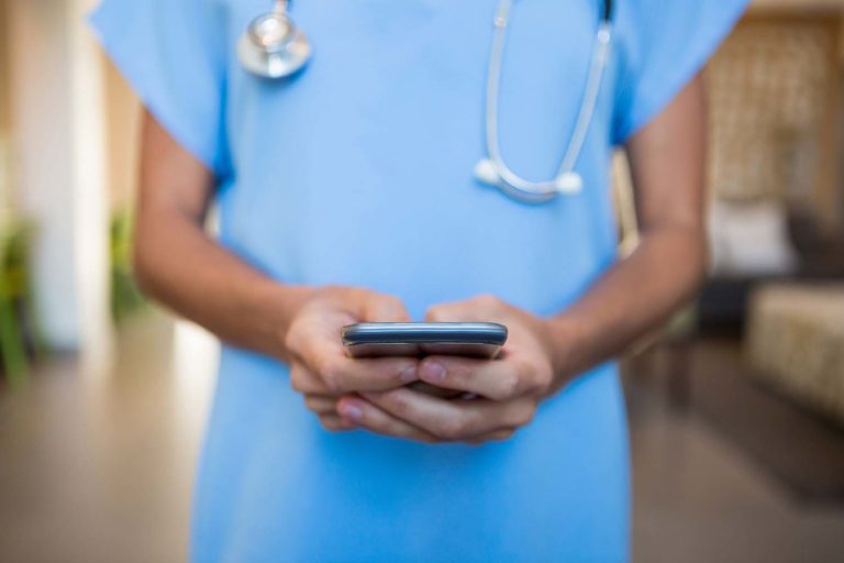 Doctor using mobile phone in hospital