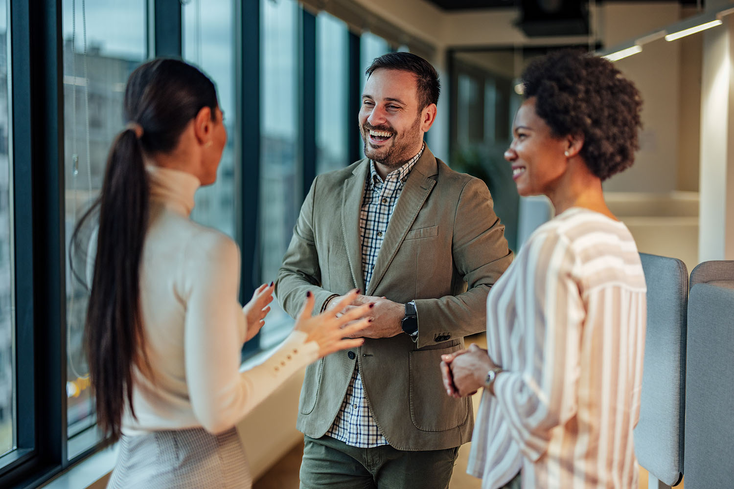 Cheerful male manager, motivating his team to work by making the