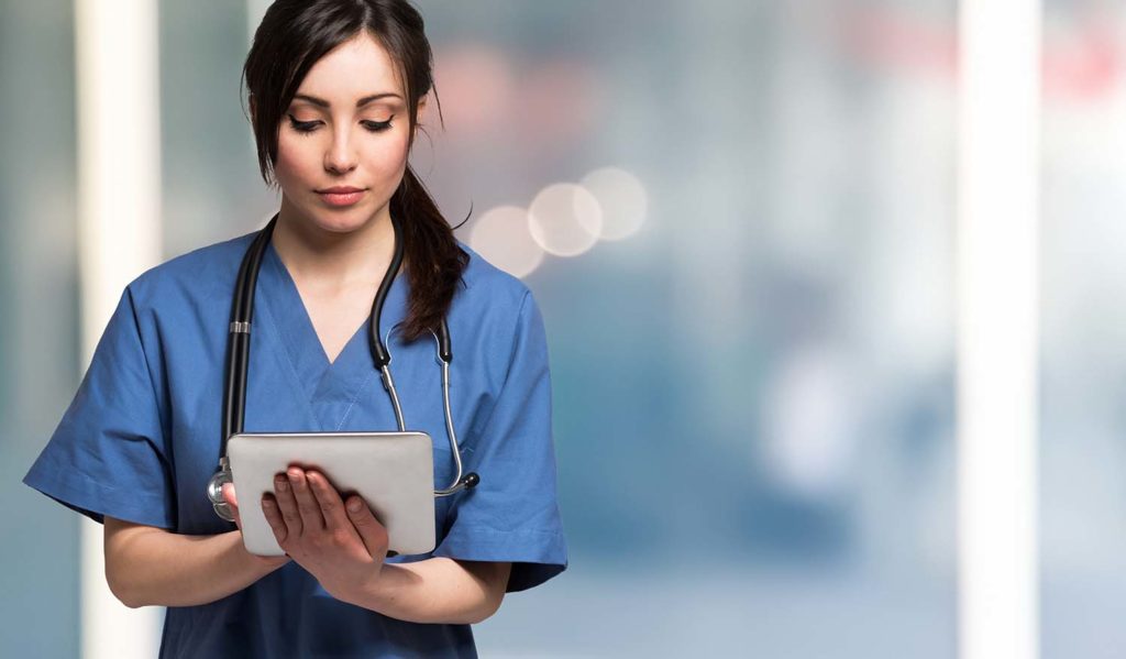 Portrait of a nurse using a digital tablet. Large copy-space