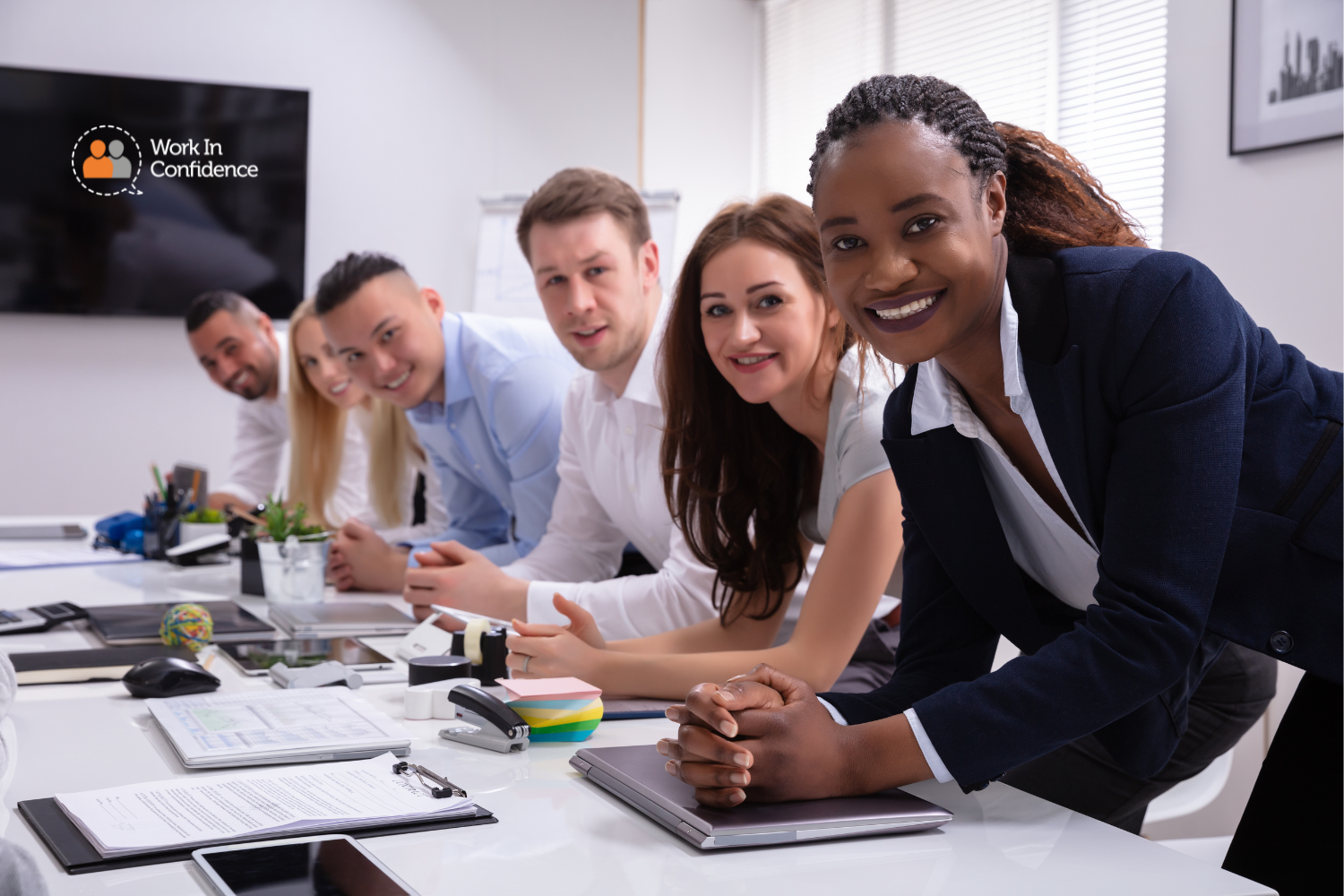 people at work looking into a camera