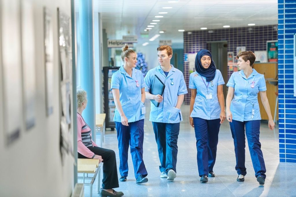 nurses walking along a hospital corridor